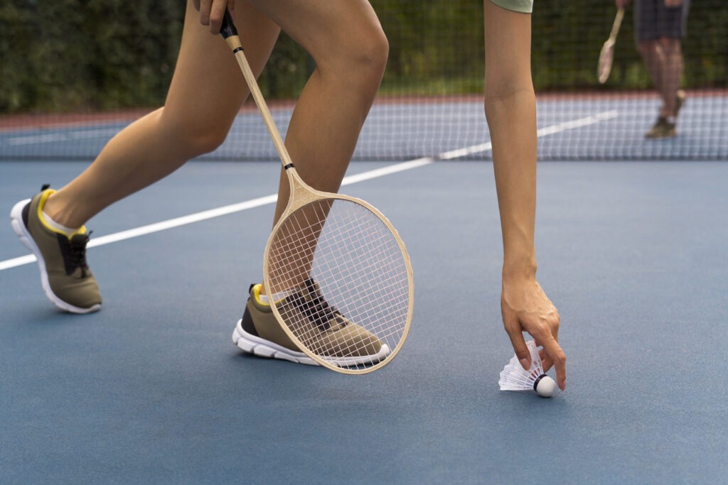 Side view woman holding shuttlecock