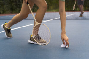 Side view woman holding shuttlecock