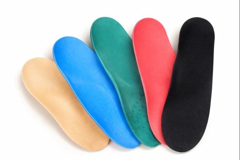 Colorful orthopedic shoe insoles arranged side by side, showing different arch support designs for walking comfort and foot pain relief